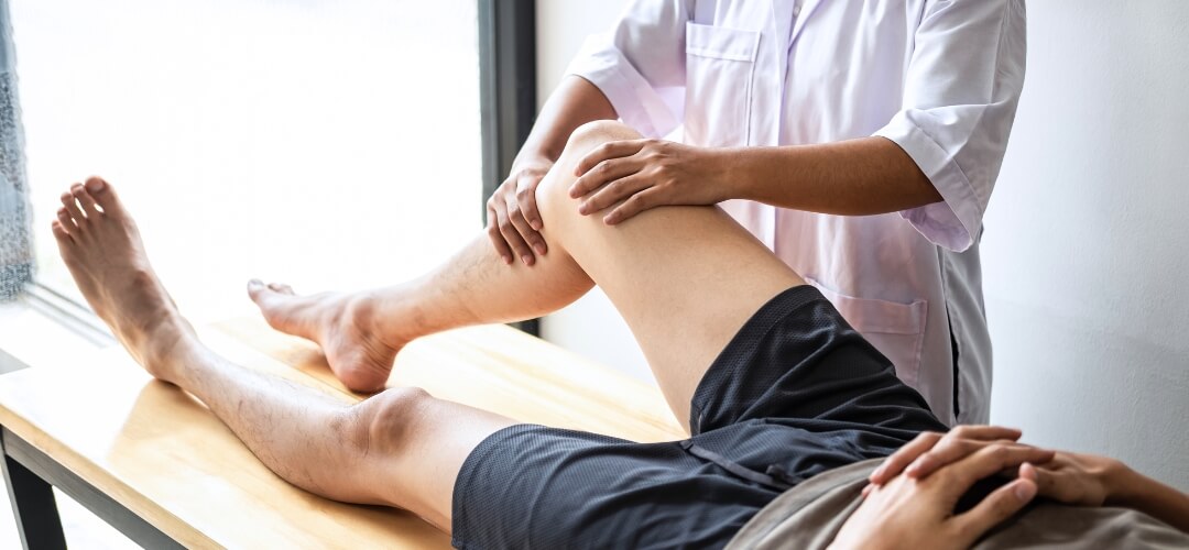 Sports therapist raising the knee