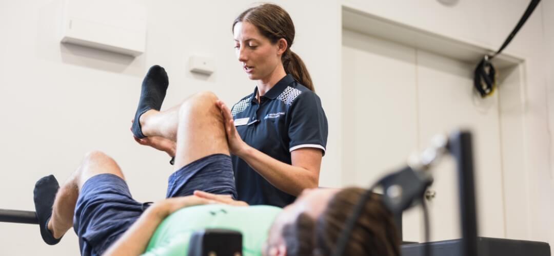 Physiotherapist working on leg flexibility